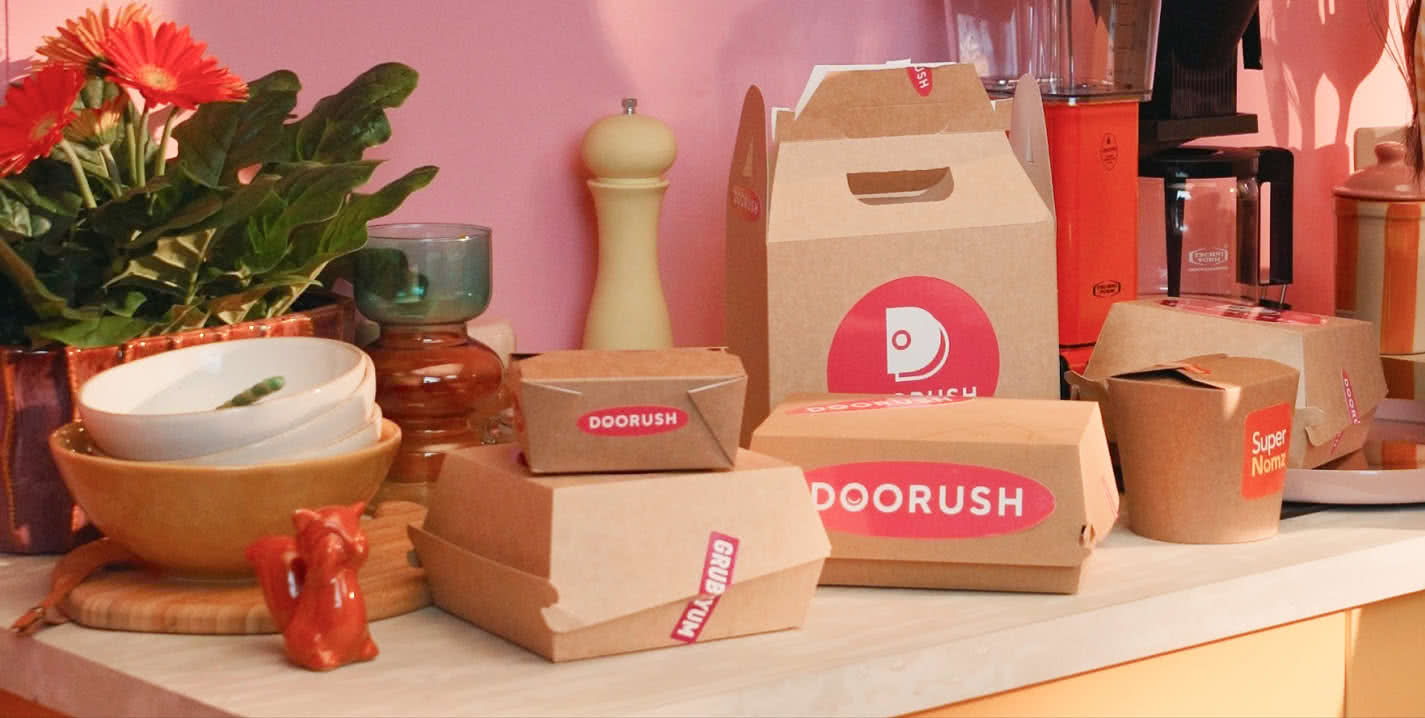 Messy countertop stacked with takeout boxes