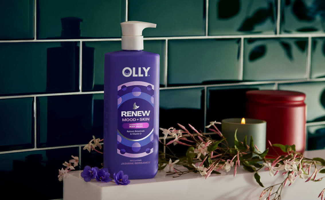 Renew Mood + Skin Body Wash next to flowers and candles